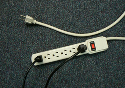 Power Supply Cable Plugged into Power Strip